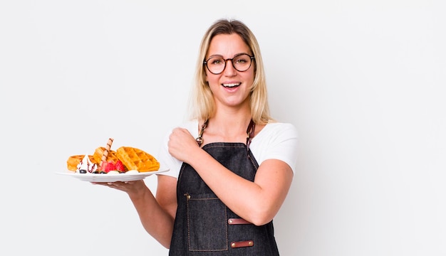 Smiling home cook holding a finished dish